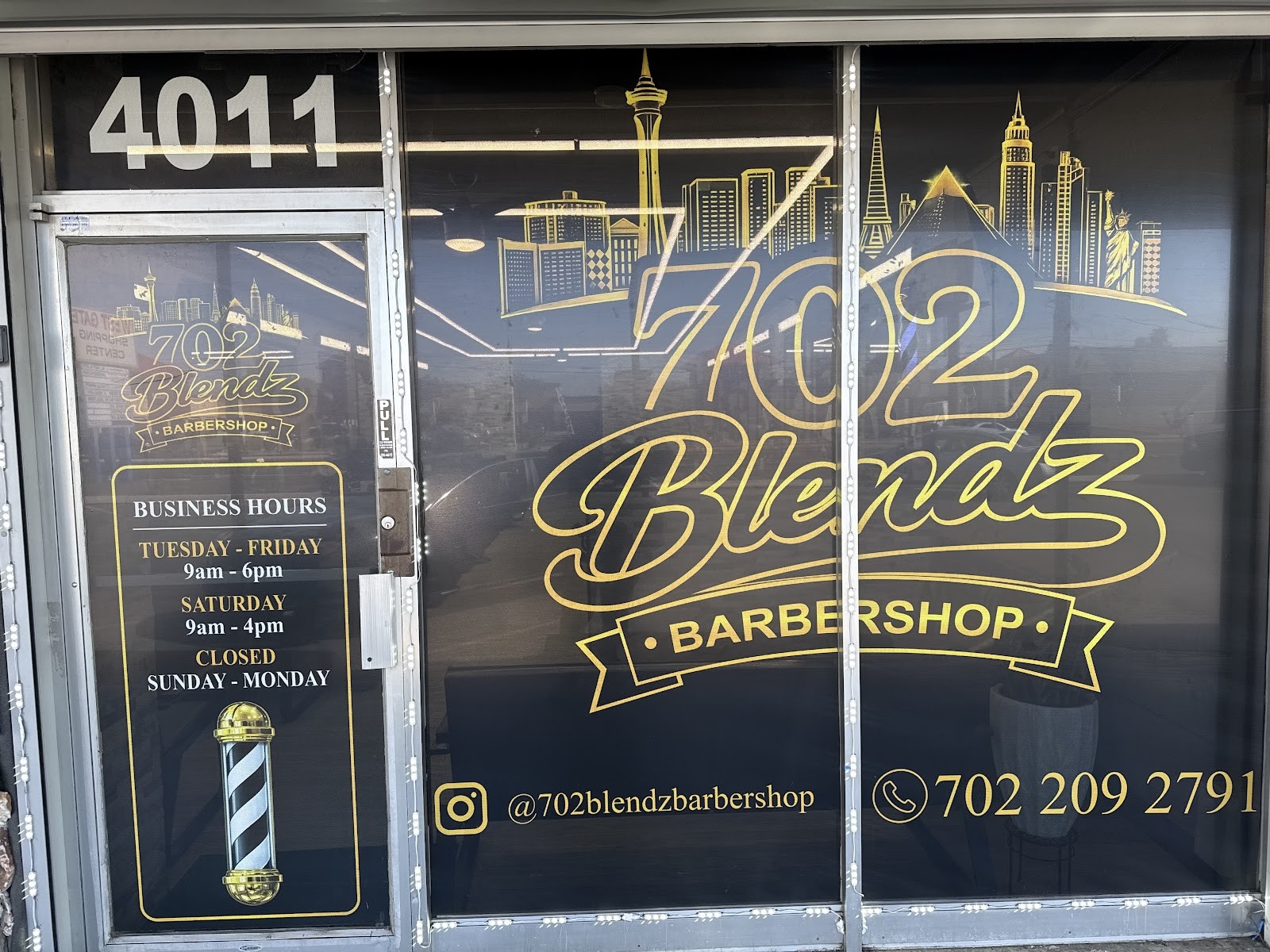 702 Blendz Barbershop window decal with logo, hours, and contact info