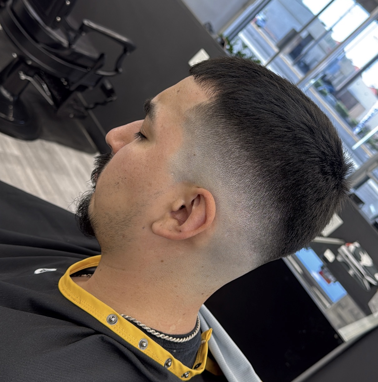 Side profile of client with clean short fade haircut